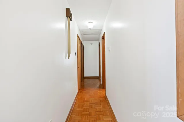 a view of a hallway with white walls