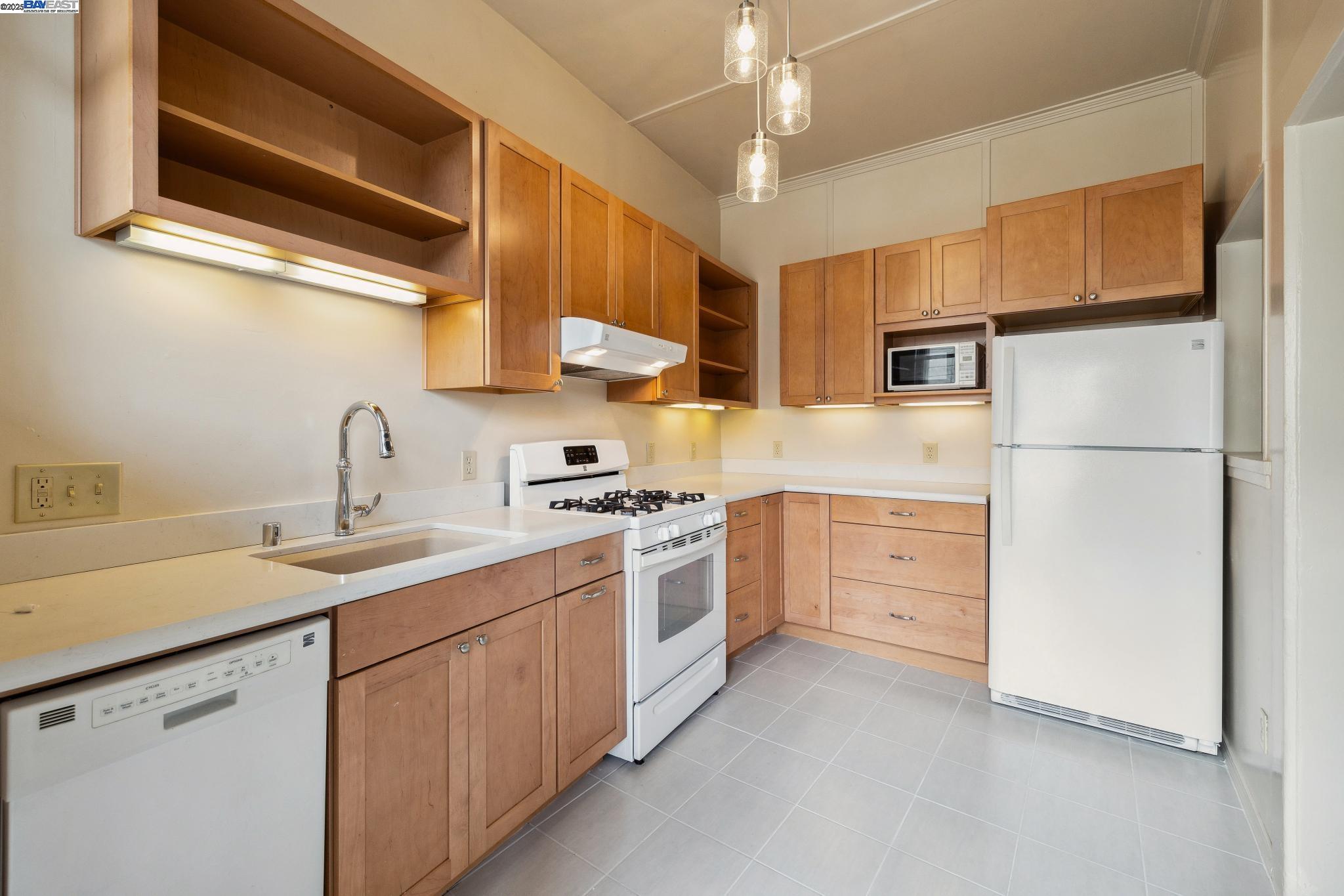 1820 3rd Street Alameda, CA 94501 - Photo 37 of 60 a kitchen with stainless steel appliances granite countertop a sink stove and refrigerator