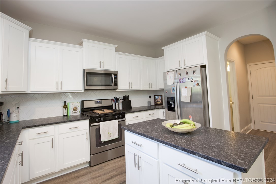 474 Kerr Lake Road Aberdeen, NC 28315 - Photo 17 of 47 a kitchen with a sink a stove and refrigerator