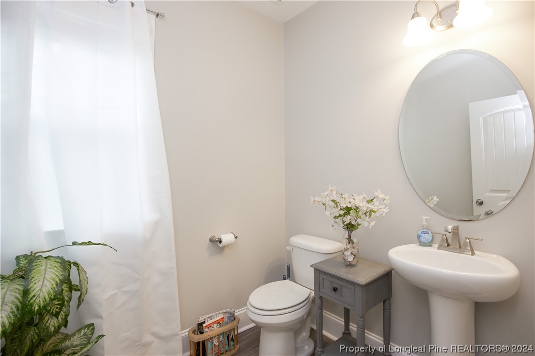 474 Kerr Lake Road Aberdeen, NC 28315 - Photo 19 of 47 a bathroom with a sink toilet and a mirror