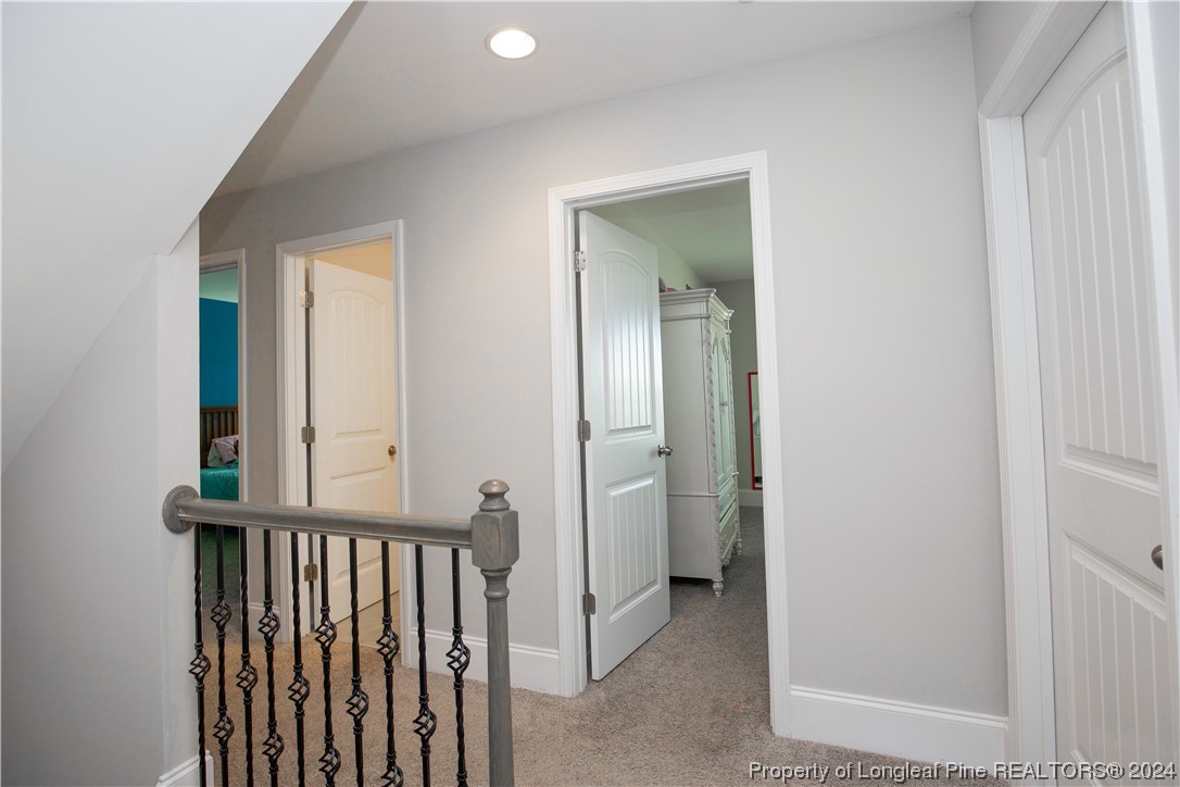 474 Kerr Lake Road Aberdeen, NC 28315 - Photo 20 of 47 a view of a hallway with a door and a mirror