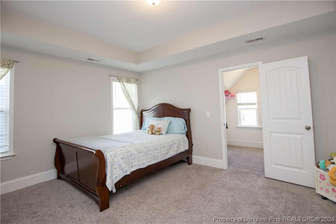 474 Kerr Lake Road Aberdeen, NC 28315 - Photo 21 of 47 a spacious bedroom with a bed and a window