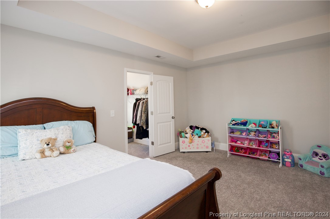 474 Kerr Lake Road Aberdeen, NC 28315 - Photo 22 of 47 a bedroom with a bed and cabinets
