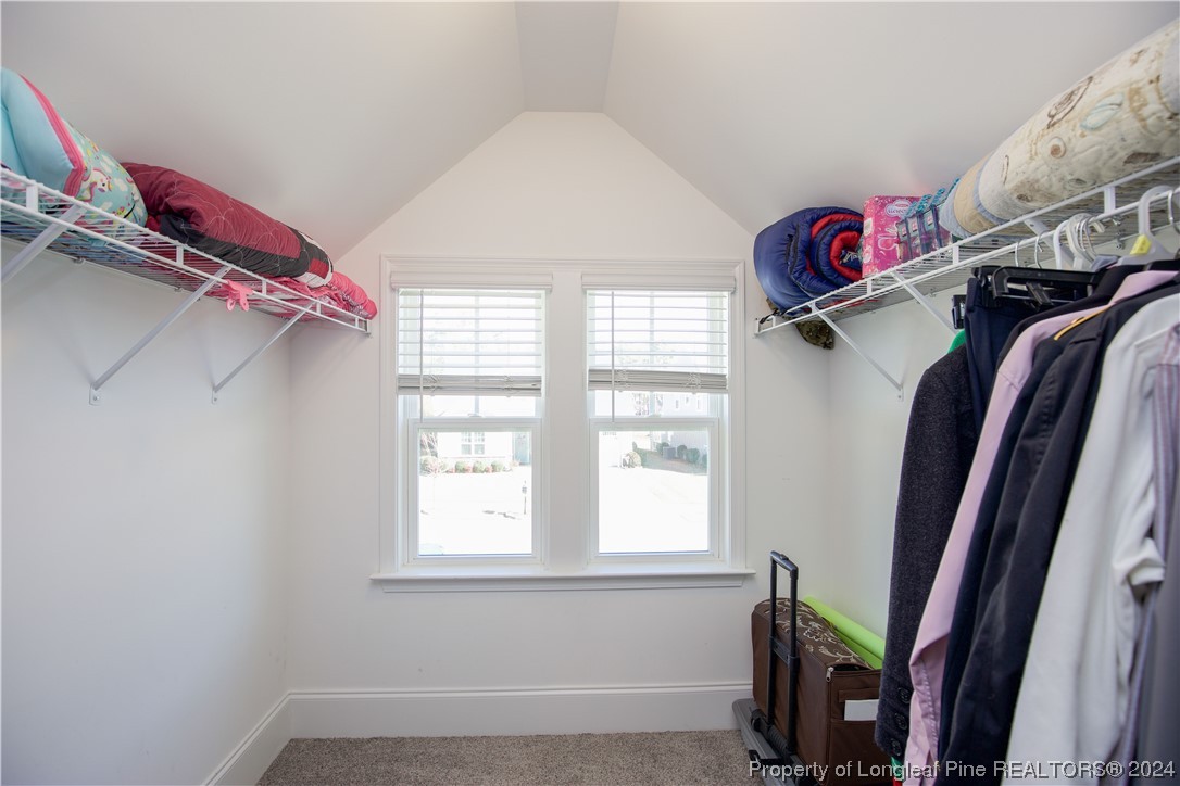 474 Kerr Lake Road Aberdeen, NC 28315 - Photo 24 of 47 a view of walk in closet with clothes and shoes