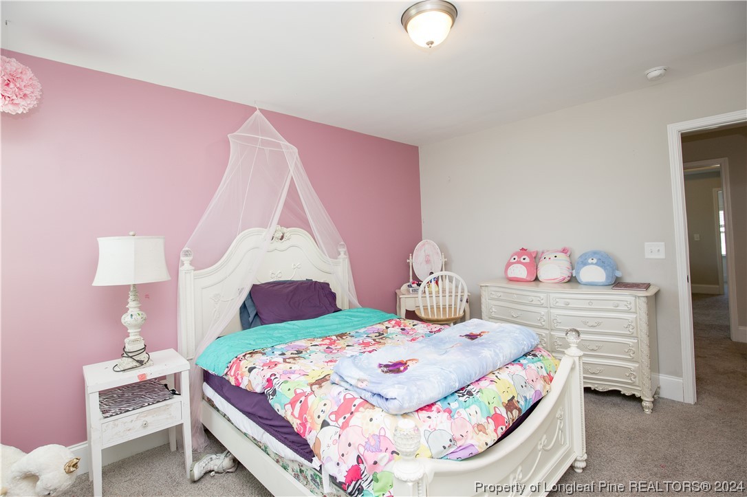 474 Kerr Lake Road Aberdeen, NC 28315 - Photo 27 of 47 a bedroom with a bed and a dresser