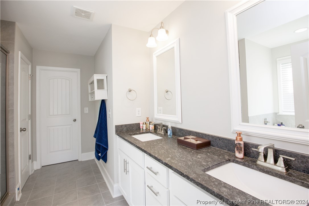 474 Kerr Lake Road Aberdeen, NC 28315 - Photo 32 of 47 a bathroom with a sink double vanity and a mirror