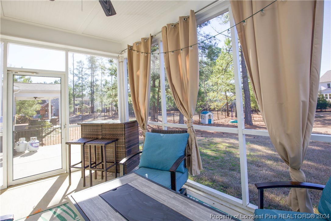 474 Kerr Lake Road Aberdeen, NC 28315 - Photo 38 of 47 a living room with furniture and a floor to ceiling window