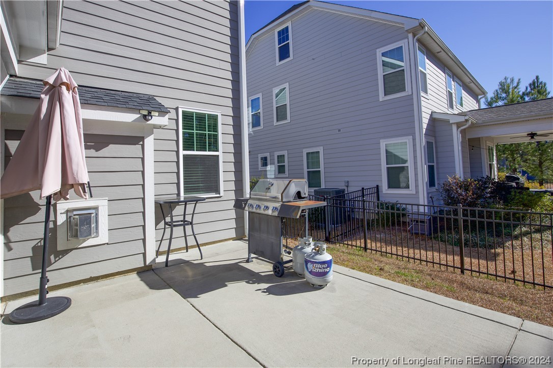 474 Kerr Lake Road Aberdeen, NC 28315 - Photo 40 of 47 a view of a patio with a table and chairs