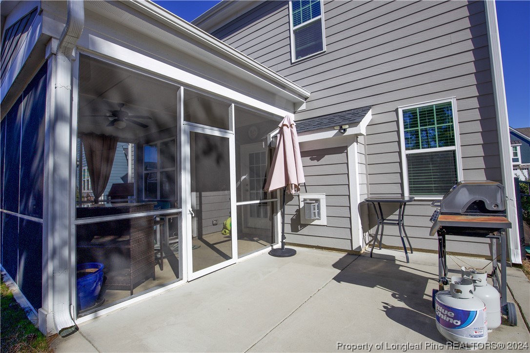 474 Kerr Lake Road Aberdeen, NC 28315 - Photo 41 of 47 a view of a patio with table and chairs and wooden floor