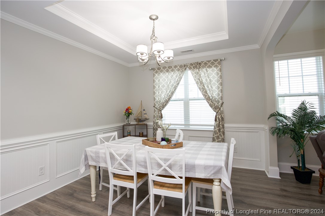 474 Kerr Lake Road Aberdeen, NC 28315 - Photo 6 of 47 a dining room with furniture potted plants and wooden floor