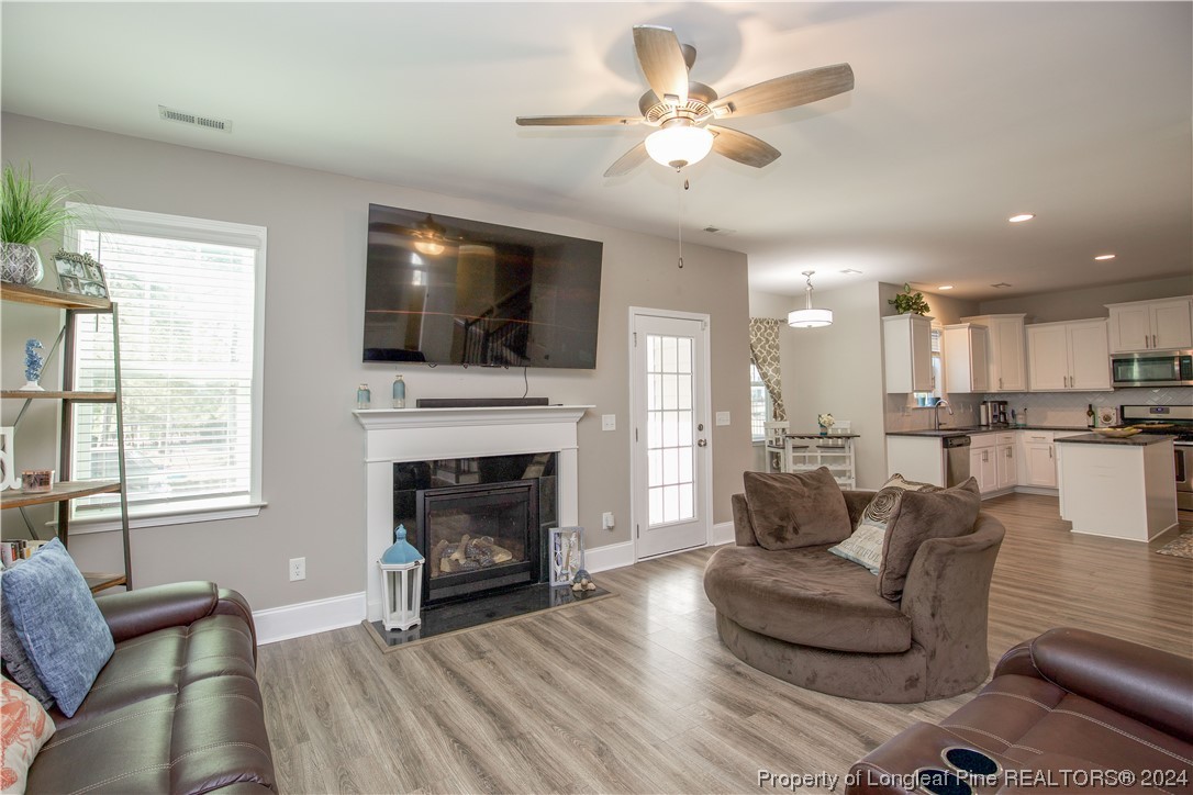 474 Kerr Lake Road Aberdeen, NC 28315 - Photo 8 of 47 a living room with furniture a flat screen tv and a fireplace