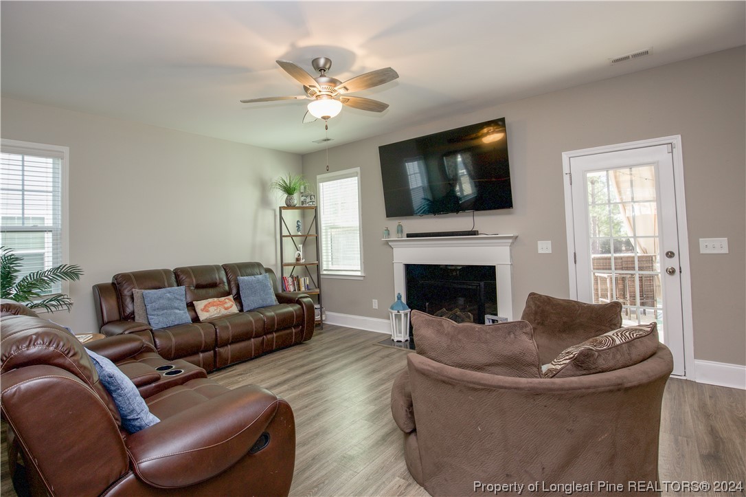 474 Kerr Lake Road Aberdeen, NC 28315 - Photo 9 of 47 a living room with furniture and a fireplace