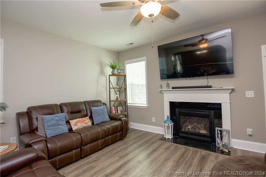 474 Kerr Lake Road Aberdeen, NC 28315 - Photo 10 of 47 a living room with furniture a flat screen tv and a fireplace