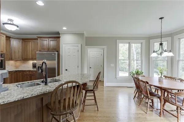 a bedroom with a bed a dresser and a large window