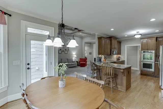 a bathroom with a granite countertop tub shower vanity and a sink