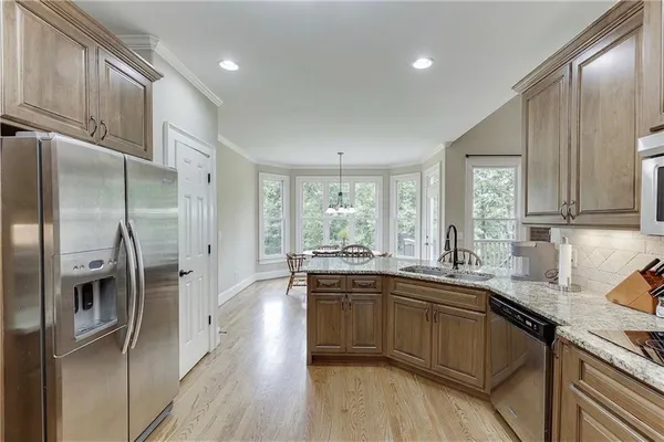 a bathroom with a granite countertop tub shower vanity and a sink