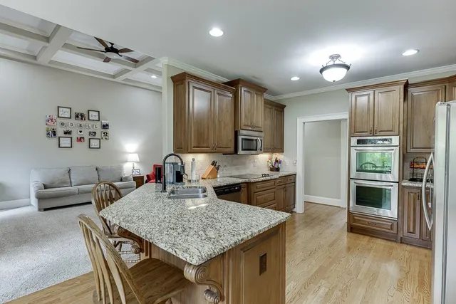 a en suite bathroom with a granite countertop sink and a mirror