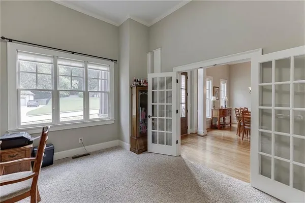a bedroom with a bed and a large window