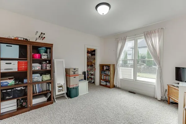 a bedroom with a bed and a large mirror