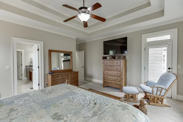 a utility room with stainless steel appliances kitchen island granite countertop a sink and cabinets