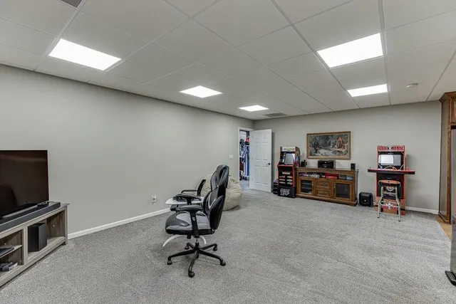 a view of a patio with table and chairs with wooden floor and fence