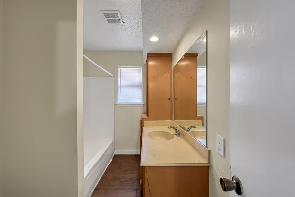 a bathroom with a sink and mirror