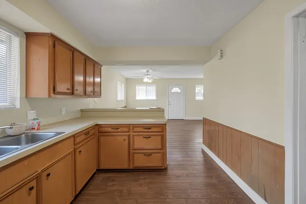 a kitchen with a sink stove and cabinets