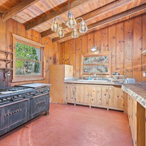 10000 Little Applegate Road Jacksonville, OR 97530 - Photo 19 of 141 a kitchen with stainless steel appliances granite countertop a stove a sink and a granite counter tops with white cabinets next to a window