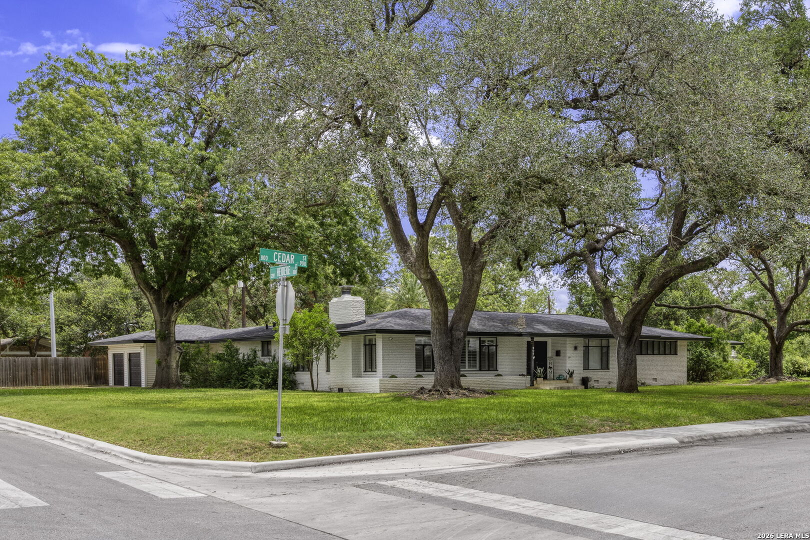 906 East Cedar Street Seguin, TX 78155 - Photo 1 of 22 a view of a big house with a big yard and large trees
