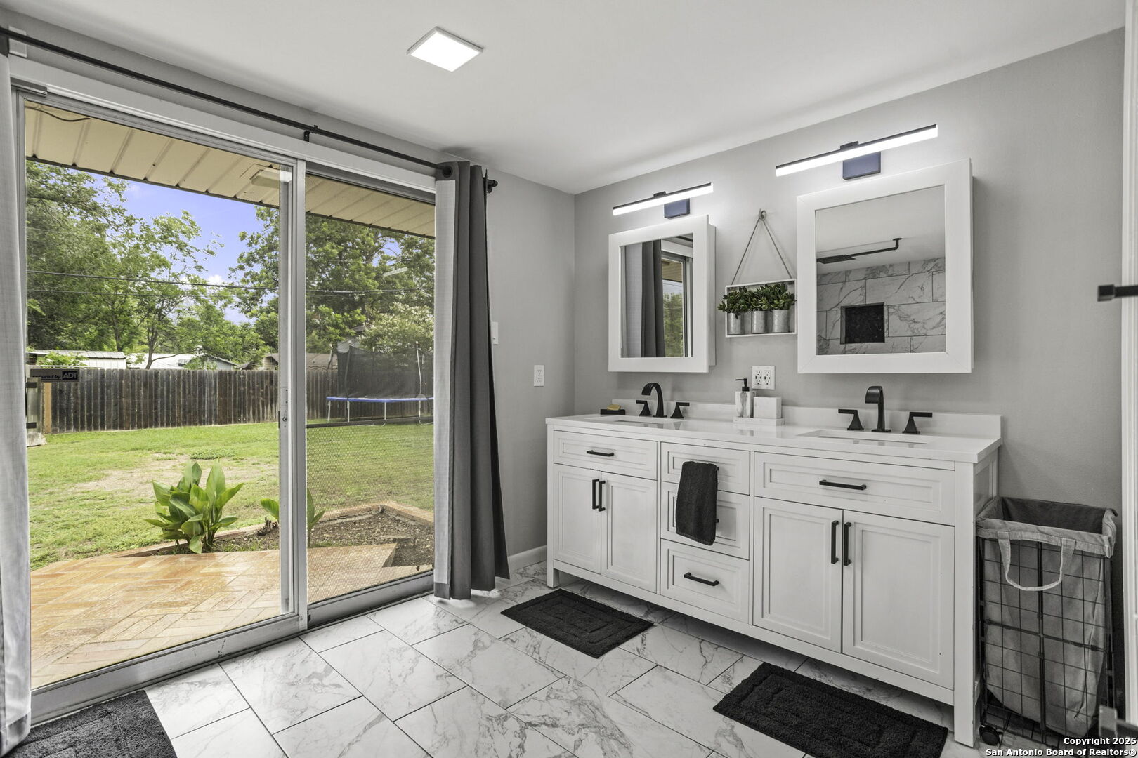906 East Cedar Street Seguin, TX 78155 - Photo 11 of 17 a spacious bathroom with a double vanity sink and a large mirror