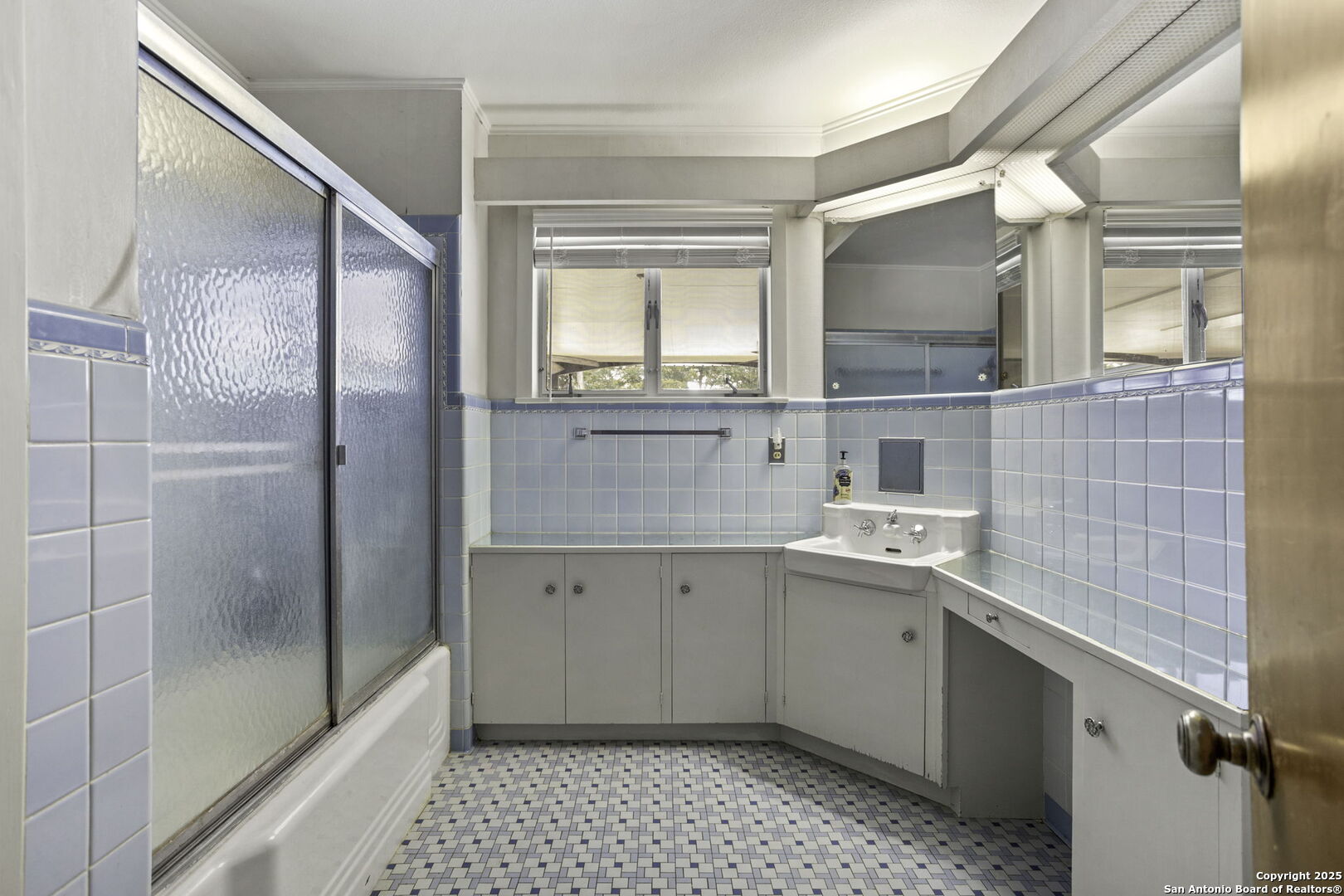 906 East Cedar Street Seguin, TX 78155 - Photo 19 of 22 a bathroom with a sink a mirror and a shower