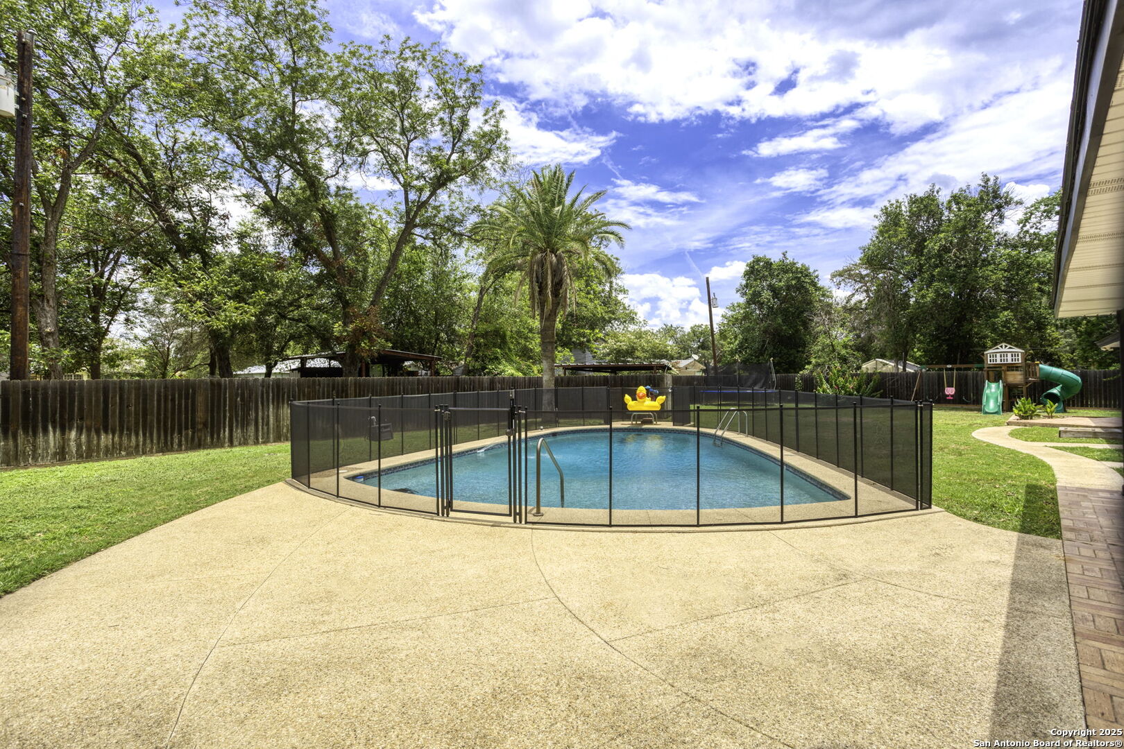 906 East Cedar Street Seguin, TX 78155 - Photo 21 of 22 a view of a swimming pool with a patio and a yard