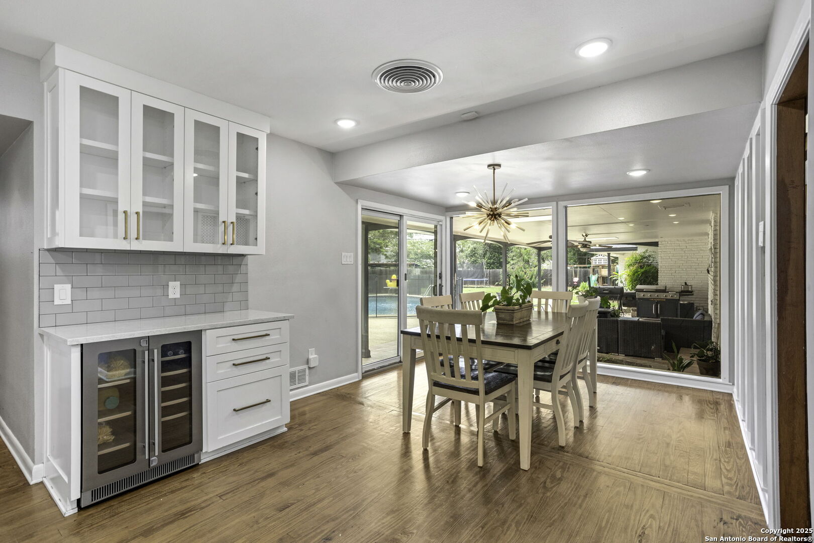 906 East Cedar Street Seguin, TX 78155 - Photo 8 of 17 a dining room with furniture a floor to ceiling window and wooden floor