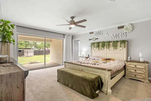 a bedroom with a bed and a large window with outer view
