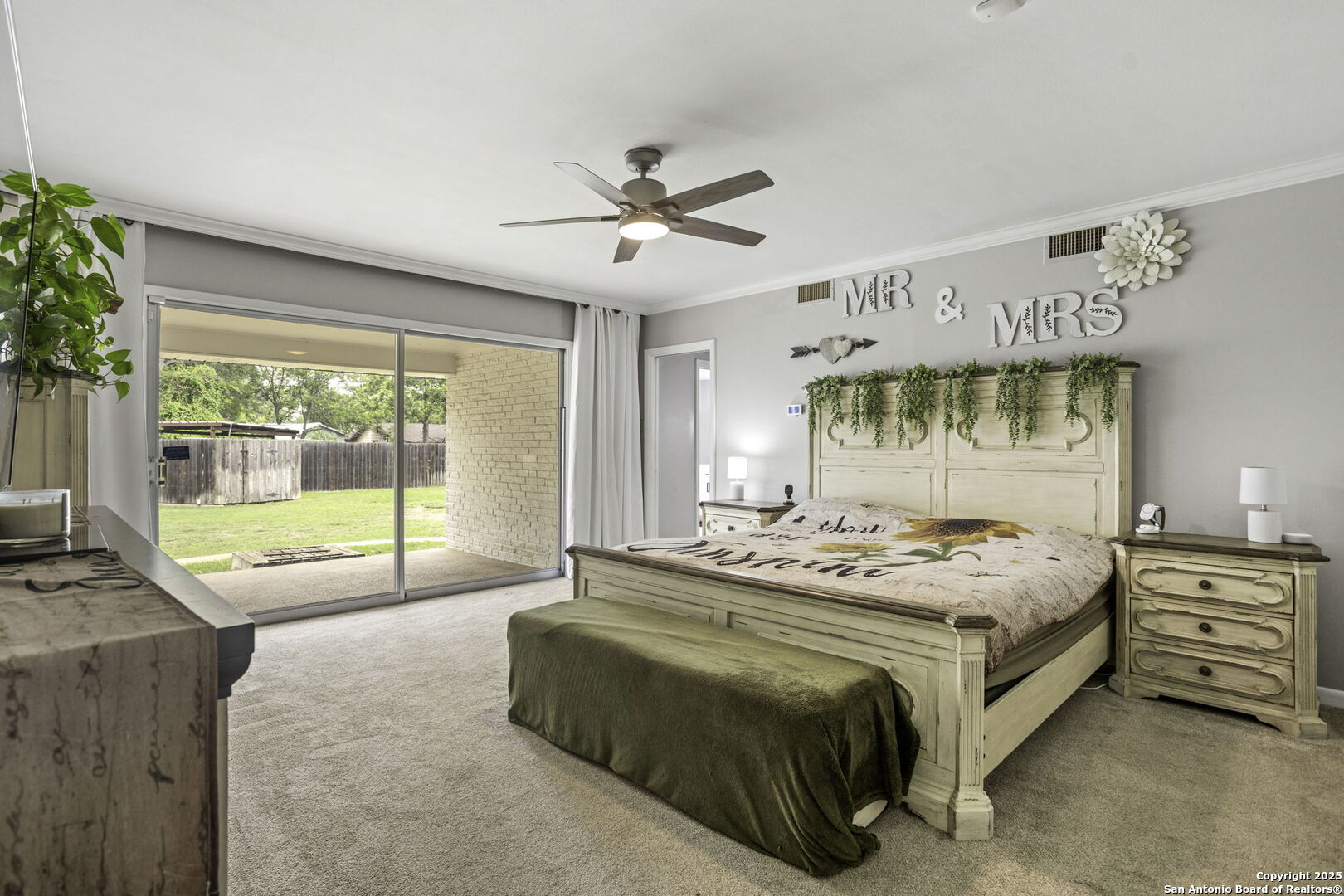 906 East Cedar Street Seguin, TX 78155 - Photo 9 of 17 a bedroom with a bed and a large window with outer view