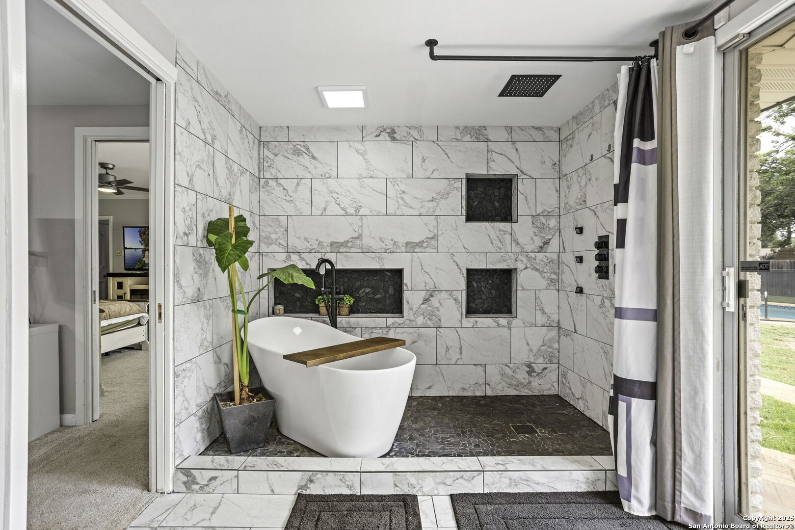 906 East Cedar Street Seguin, TX 78155 - Photo 10 of 17 a white bath tub sitting in a bathroom next to a window