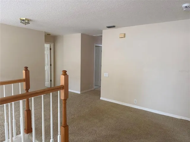 a view of a hallway with staircase