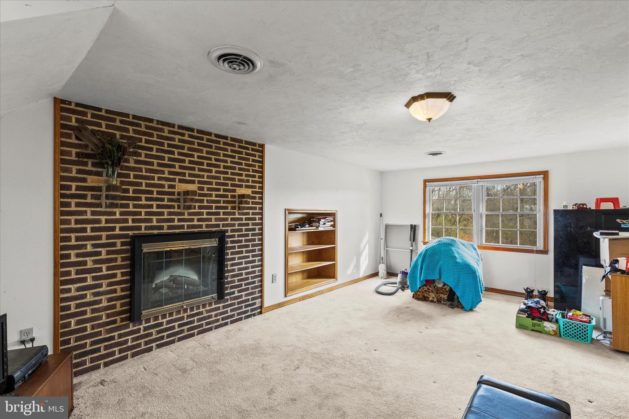 181 Gooseville Road New Oxford, PA 17350 - Photo 17 of 45 a living room with a fireplace furniture and a flat screen tv