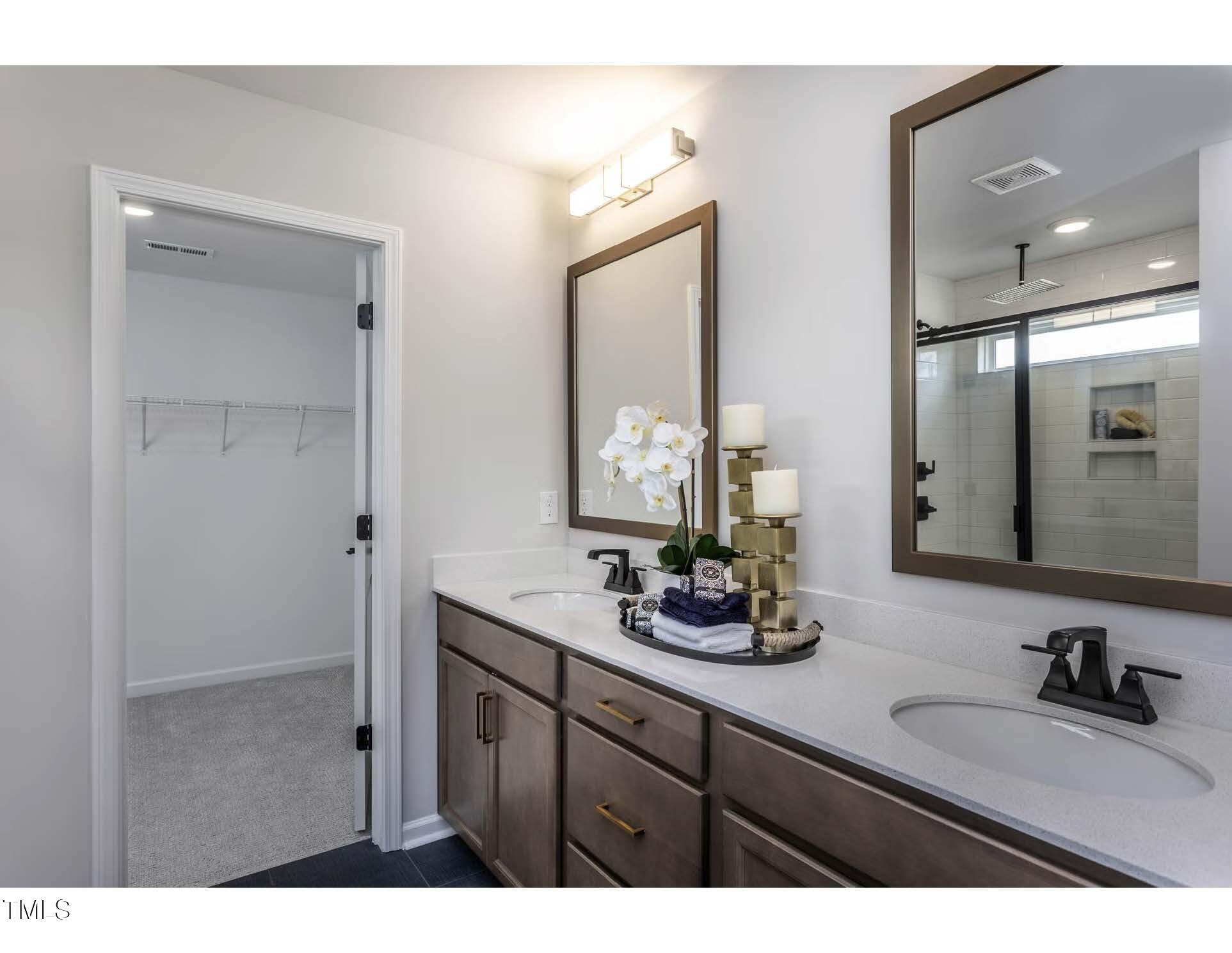 272 White Azalea Way Benson, NC 27504 - Photo 13 of 24 a bathroom with double vanity sinks and a mirror