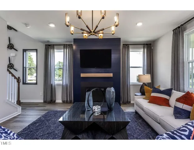 a living room with fireplace furniture and a flat screen tv