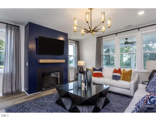 a living room with fireplace furniture and a flat screen tv