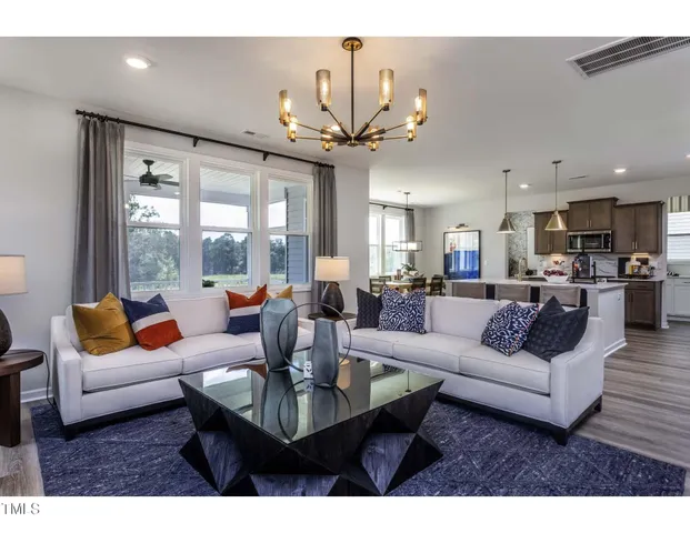 a living room with fireplace furniture and a large window