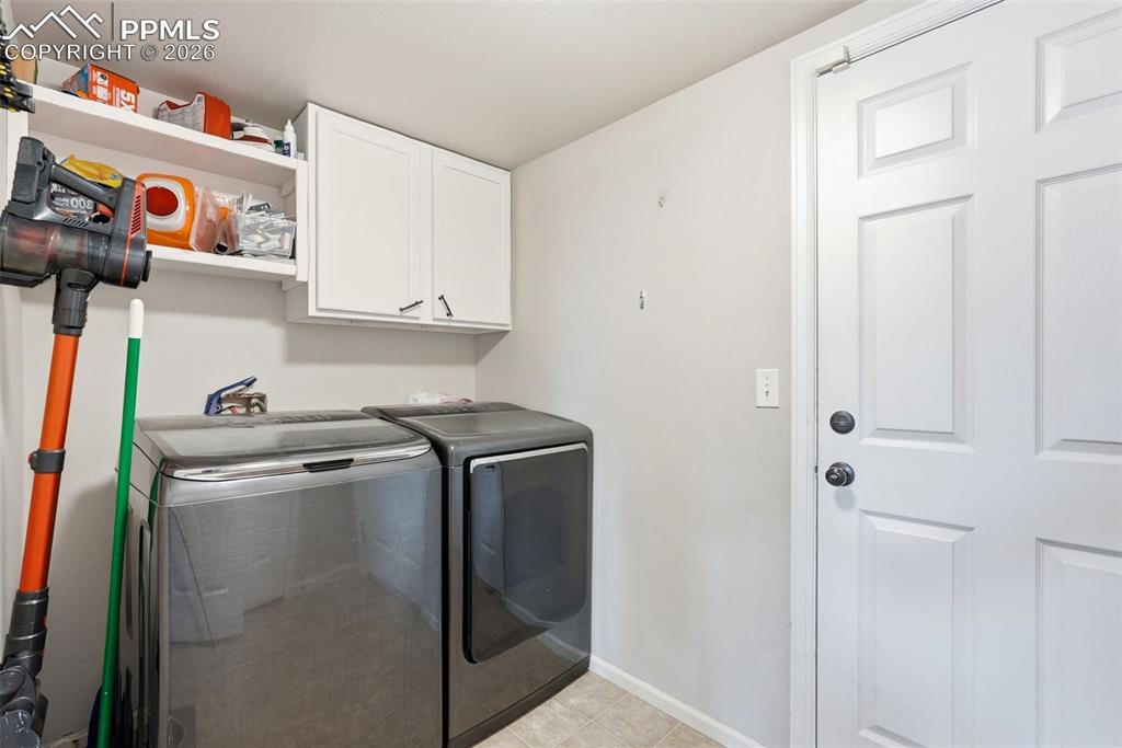 6907 Shimmering Leaf Road Colorado Springs, CO 80908 - Photo 18 of 49 a utility room with dryer and washer
