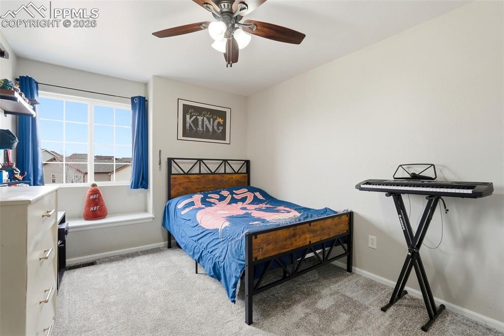 6907 Shimmering Leaf Road Colorado Springs, CO 80908 - Photo 25 of 49 a bedroom with a bed and a table