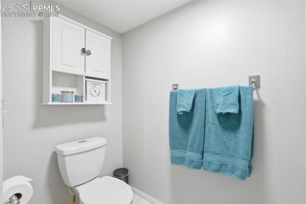 6907 Shimmering Leaf Road Colorado Springs, CO 80908 - Photo 34 of 49 a bathroom with a toilet and a shower