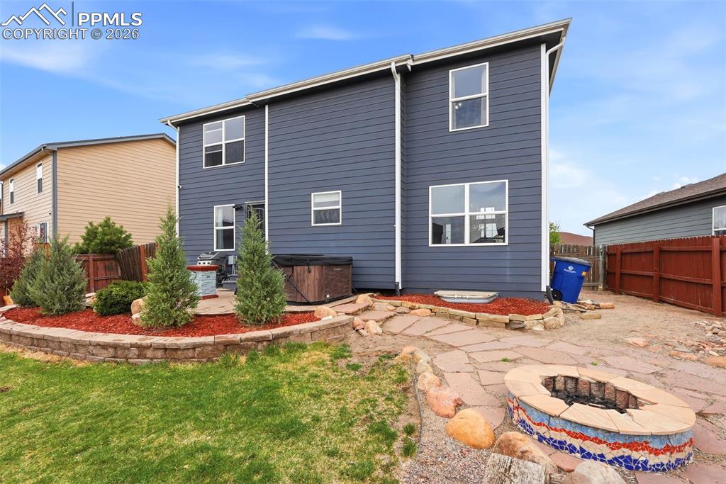 6907 Shimmering Leaf Road Colorado Springs, CO 80908 - Photo 46 of 49 a backyard of a house with yard and seating area