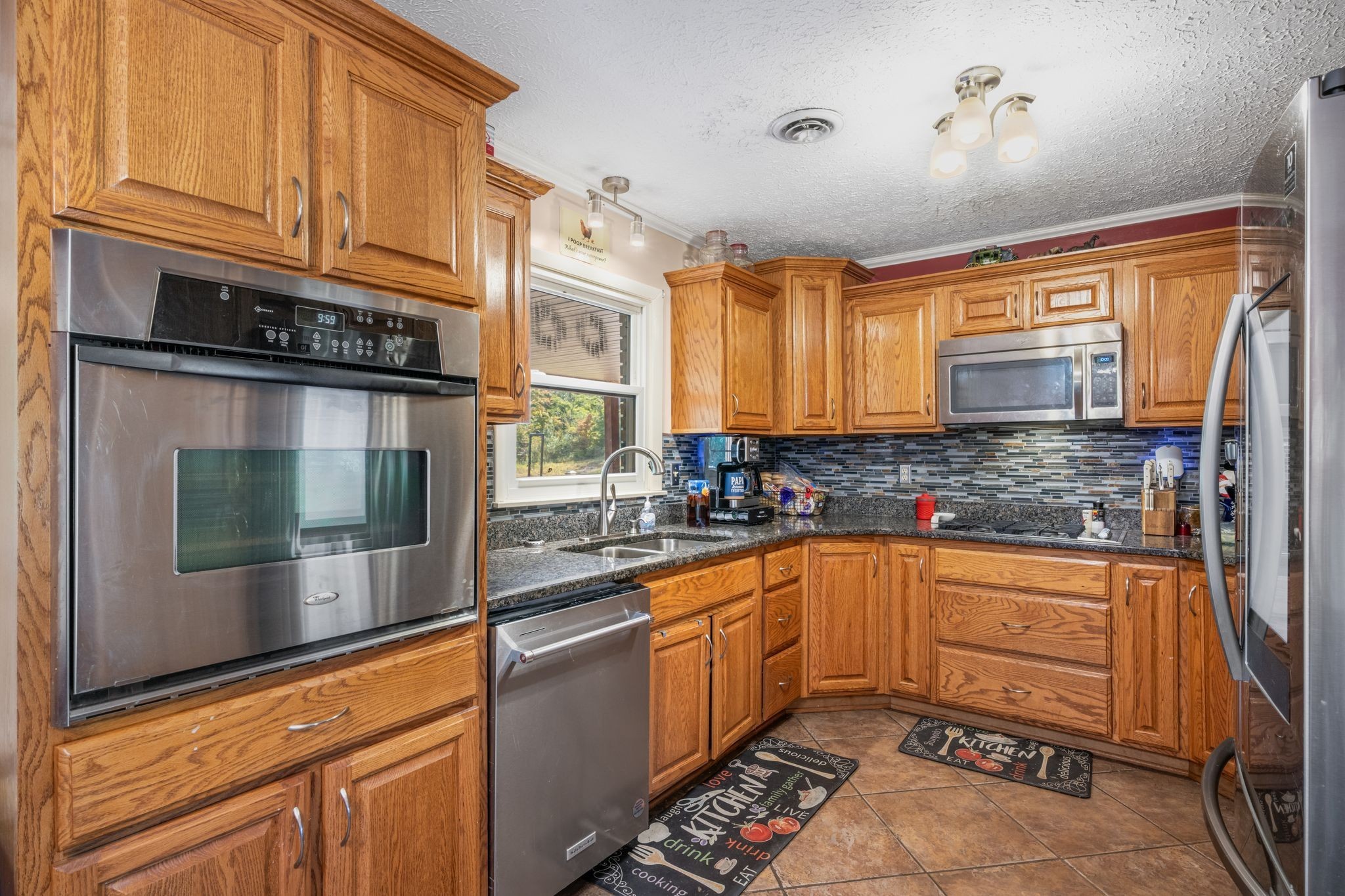 298 Langford Road Waverly, TN 37185 - Photo 14 of 53 a kitchen with granite countertop a sink and cabinets