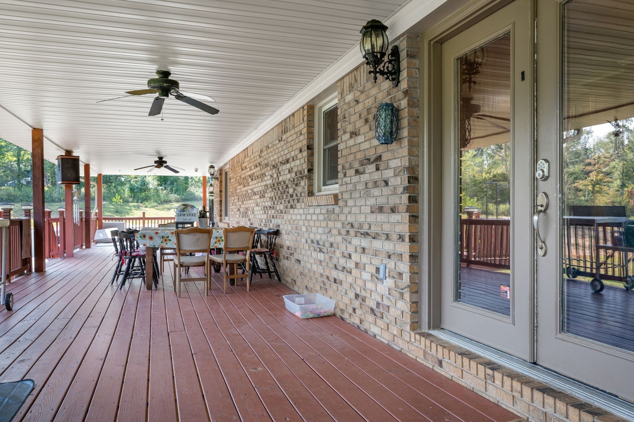 298 Langford Road Waverly, TN 37185 - Photo 35 of 53 a view of a patio with table and chairs and floor to ceiling window with wooden floor