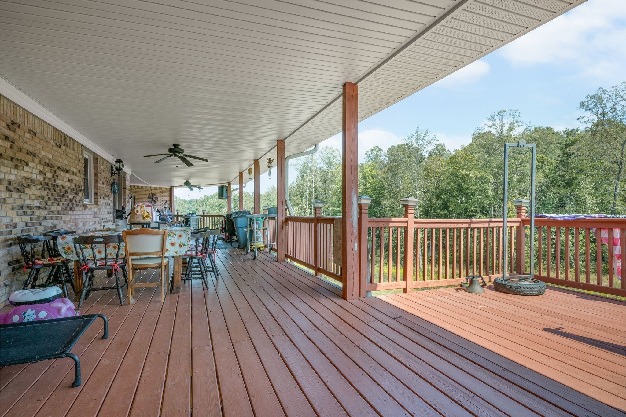 298 Langford Road Waverly, TN 37185 - Photo 36 of 53 a view of a patio with wooden floor table and chairs