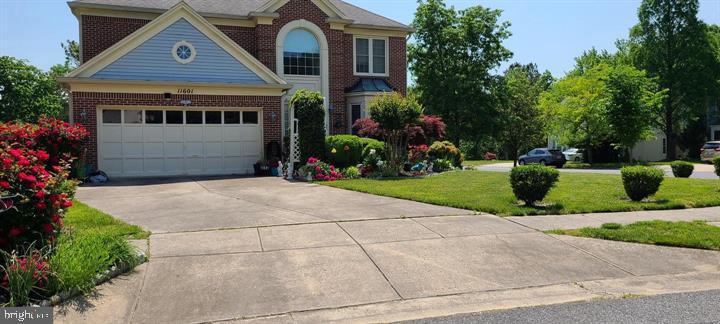 Charming brick home with lush gardens.